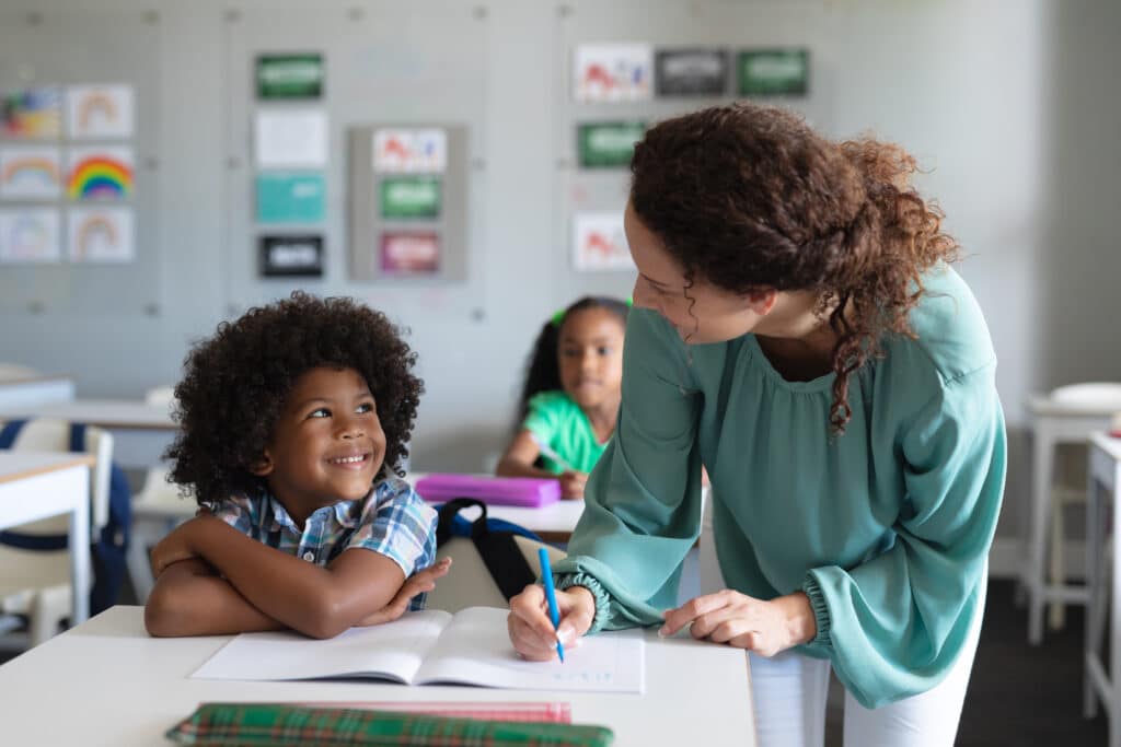 Child looking up at teacher